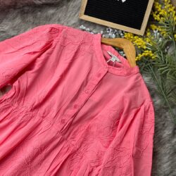 Coral pink embroidered cotton tunic dress with long sleeves, button-down front, and tiered flowy design,